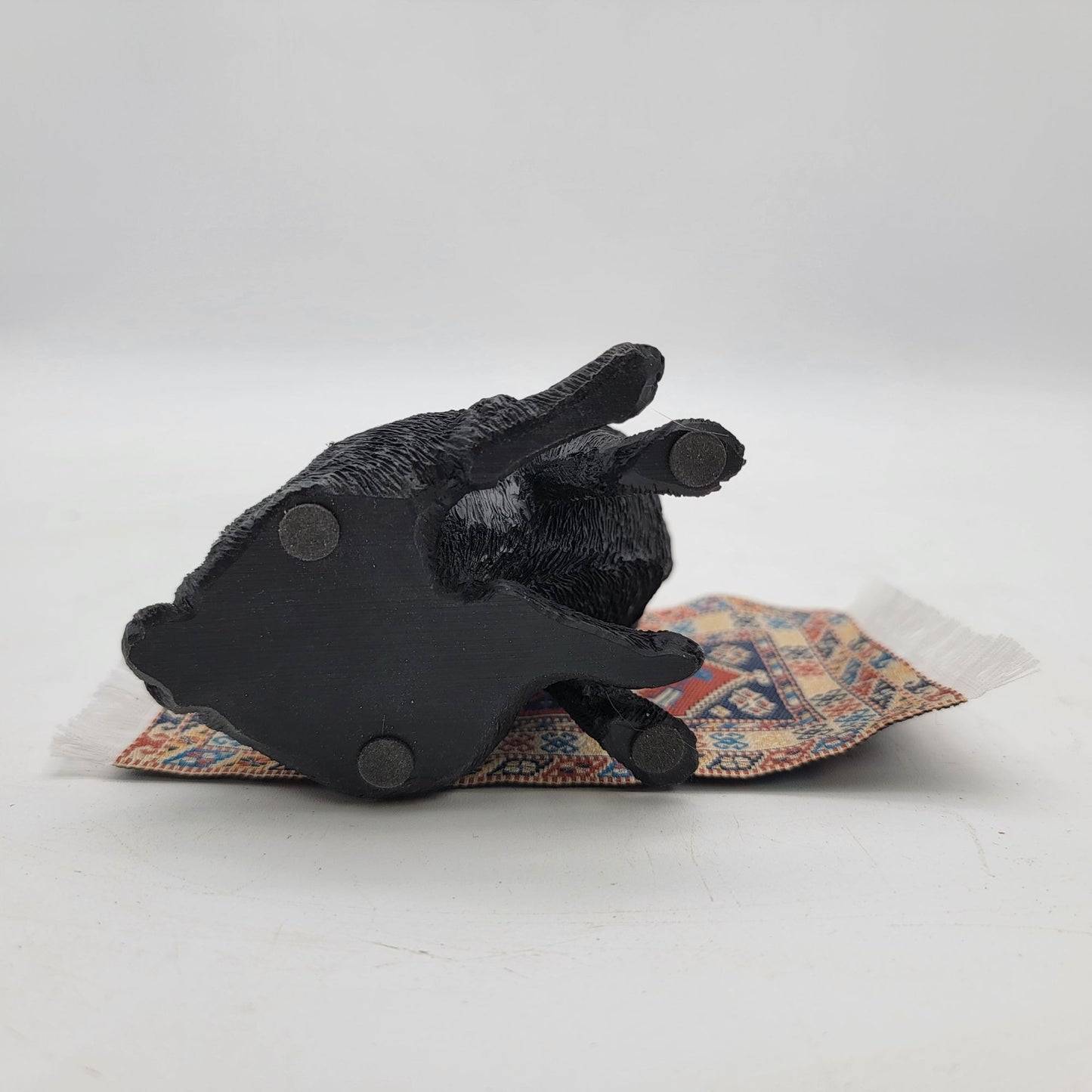 Black Pug Figurine On Miniature Oriental Rug