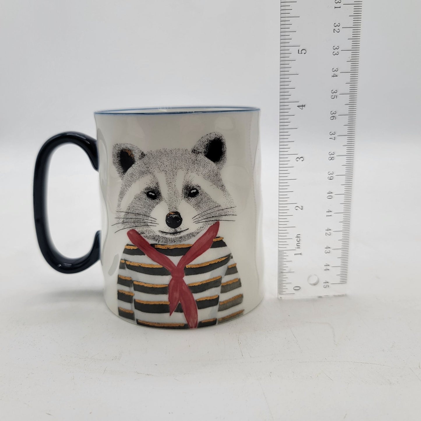 Raccoon-Themed Ceramic Mug With Navy Handle By Signature Housewares