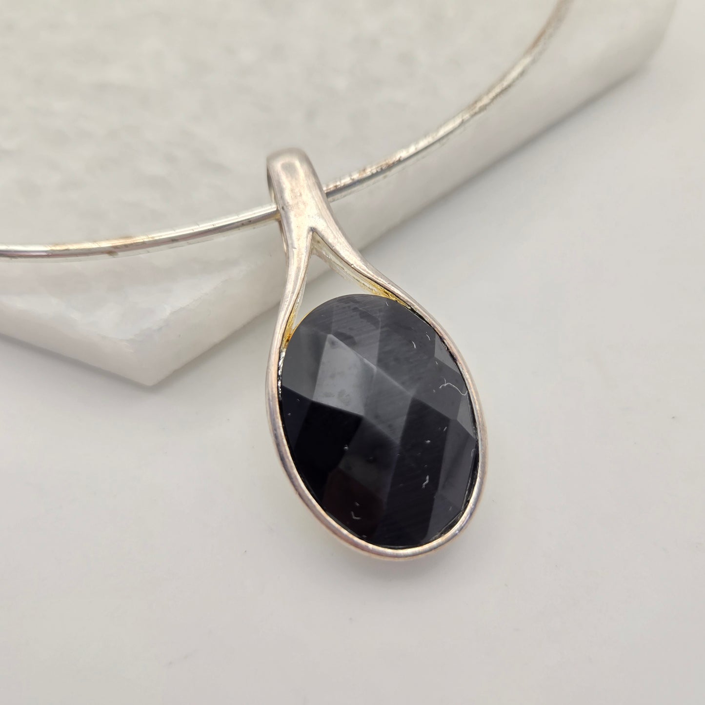 Silvertone Torque Necklace with Faceted Black Pendant