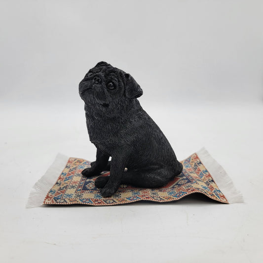 Black Pug Figurine On Miniature Oriental Rug