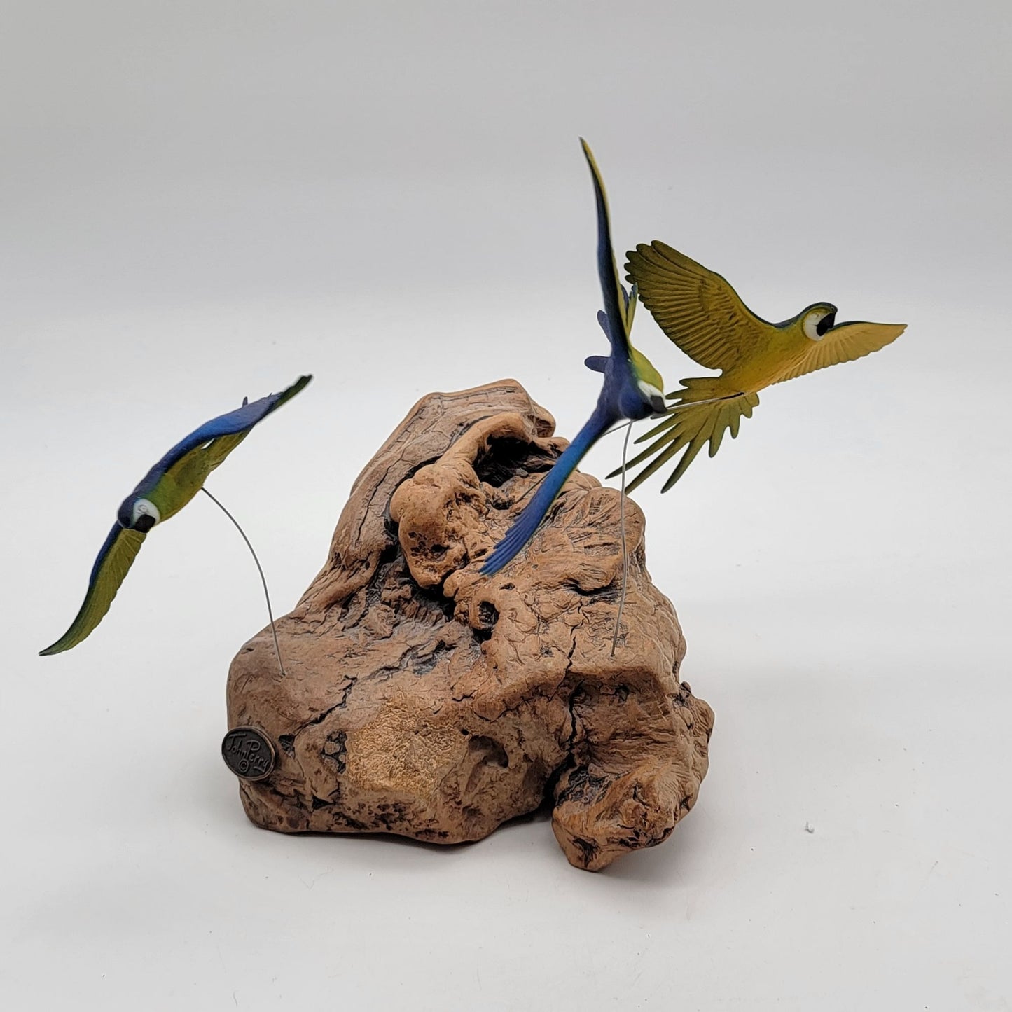 John Perry Blue and Gold Macaw Parrot Trio Sculpture On Burlwood