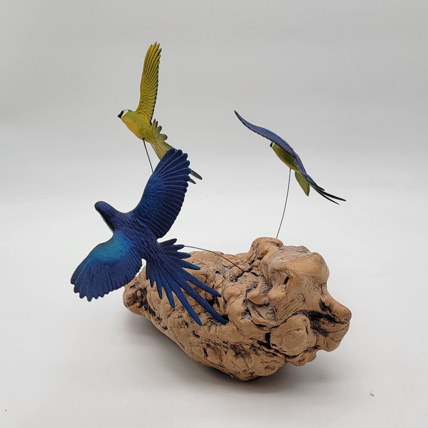 John Perry Blue and Gold Macaw Parrot Trio Sculpture On Burlwood
