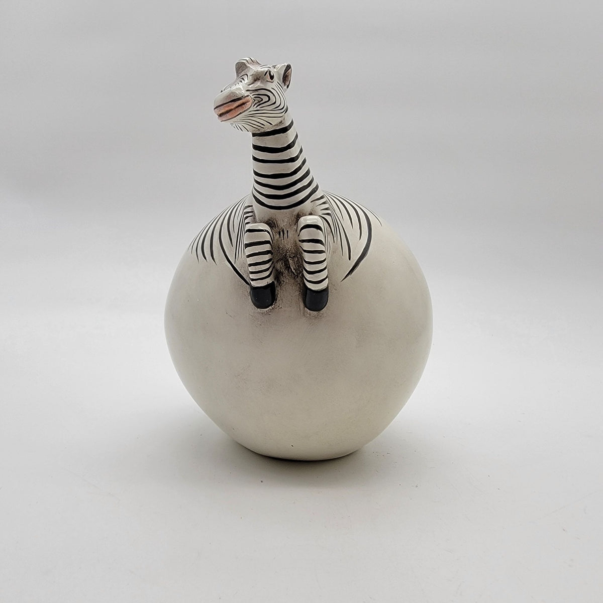 Zebra Hatching From Egg Ball Figurine
