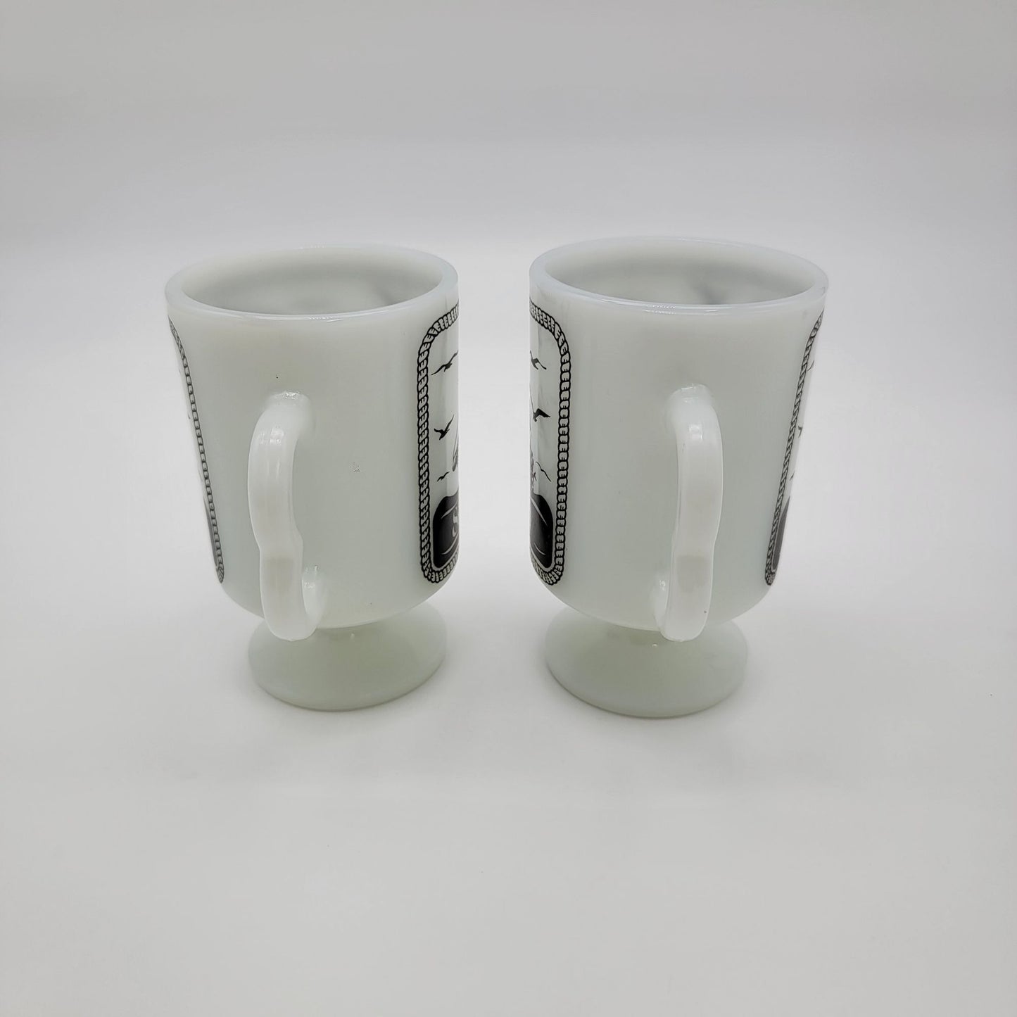 Pair of 1980 Vintage Fire King Milk Glass Sea World Footed Mugs Dolphin Orca Design