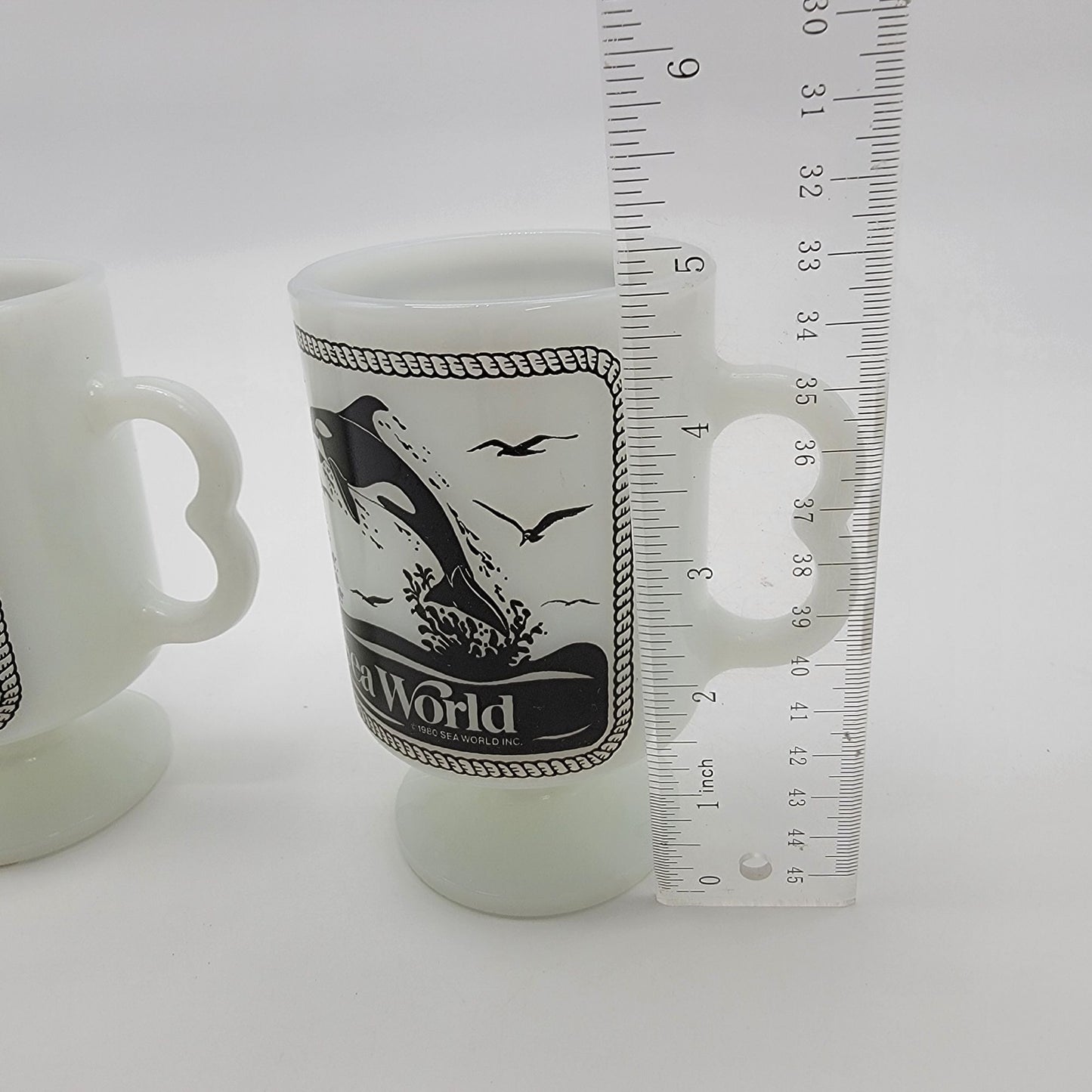 Pair of 1980 Vintage Fire King Milk Glass Sea World Footed Mugs Dolphin Orca Design